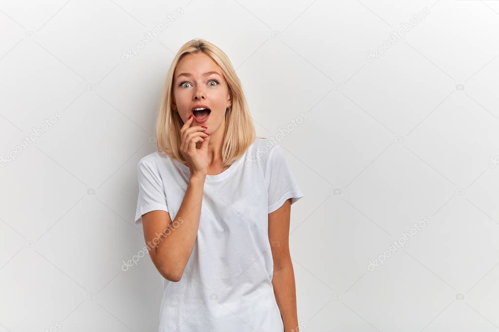 emotional excited beautiful girl touching her chin with finger finger