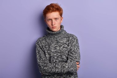 Gri sıcak kazak elleri katlanmış tutan dondurucu genç adam