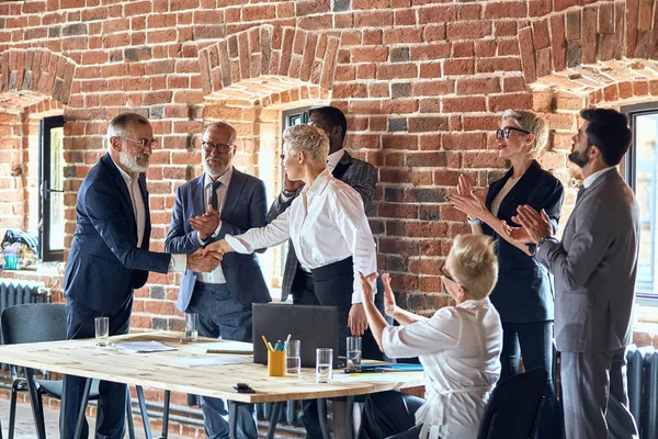 Group of business people brainstorming together in meeting room