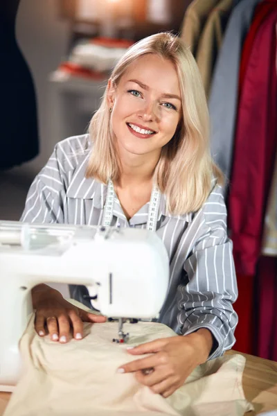 Charmig positiv kvinna reparera kläder i rummet. — Stockfoto