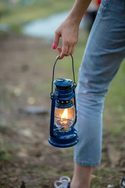 hiker girl holding old lantern.