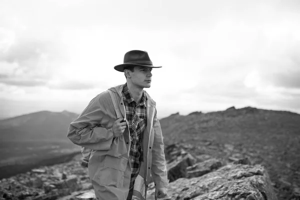 Serious handsome pensive male hiker on a top of a mountain — Stock Photo, Image