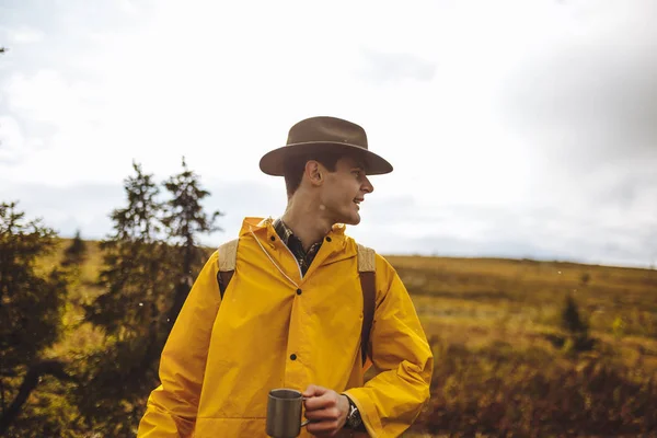 Tourism and camping concept. Hiker drinking tea or coffee while having a rest . — Stock Photo, Image