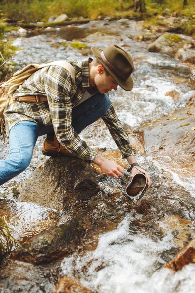 Joven excursionista sacando agua para beber — Foto de Stock