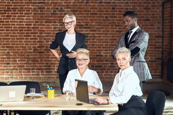 Group of business people brainstorming together in meeting room