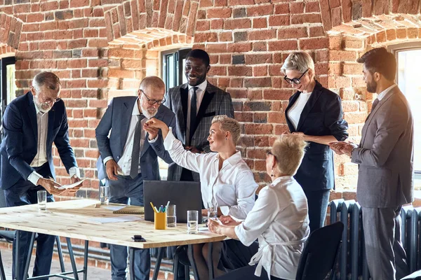 Group of business people brainstorming together in meeting room