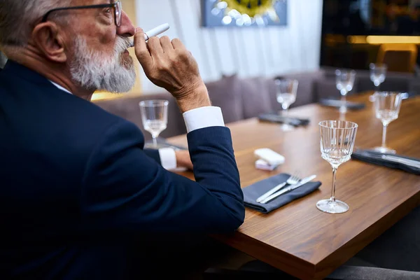 Elegante hombre mayor fumar calor-no-quemar la tecnología del producto del tabaco —  Fotos de Stock