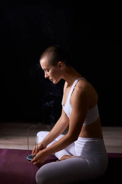 Yoga meditation at home. Caucasian woman sitting in front of aromatic sticks — Stock Photo, Image