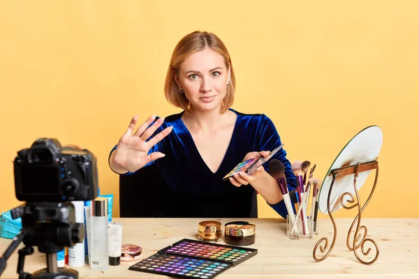 Adorable female beauty expert pulls hand towards camera, shows stop gesture — Stock Photo, Image
