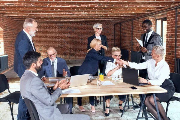 Group of business people brainstorming together in meeting room