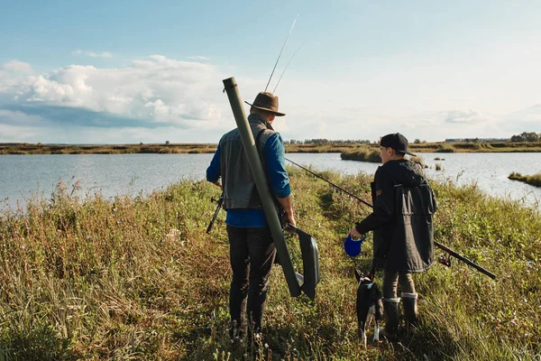 Erwachsener Vater und Teenager-Sohn gehen gemeinsam fischen. — Stockfoto