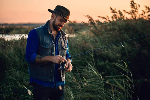 The first joint fishing of adult father and teen son in warm, sunny day. — Stock Photo, Image