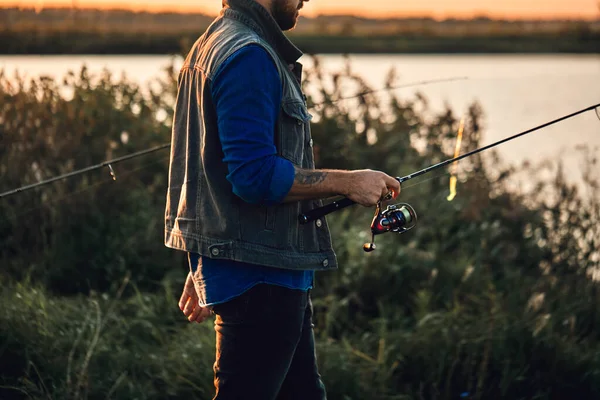 The first joint fishing of adult father and teen son in warm, sunny day. — Stock Image The first joint fishing of adult father and teen son in warm, sunny day. Stock Image