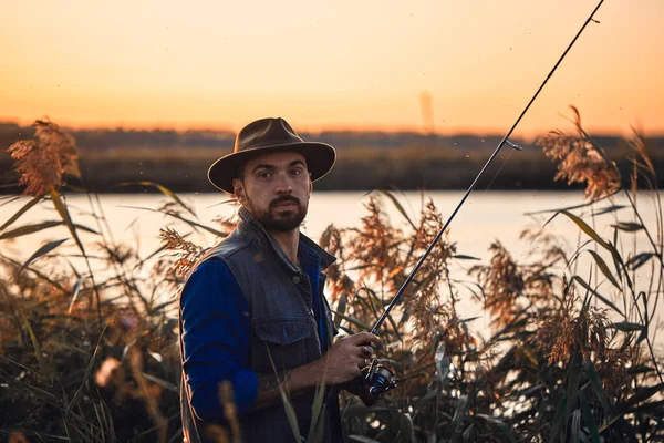 The first joint fishing of adult father and teen son in warm, sunny day. — Stock Image The first joint fishing of adult father and teen son in warm, sunny day. Royalty Free Stock Images