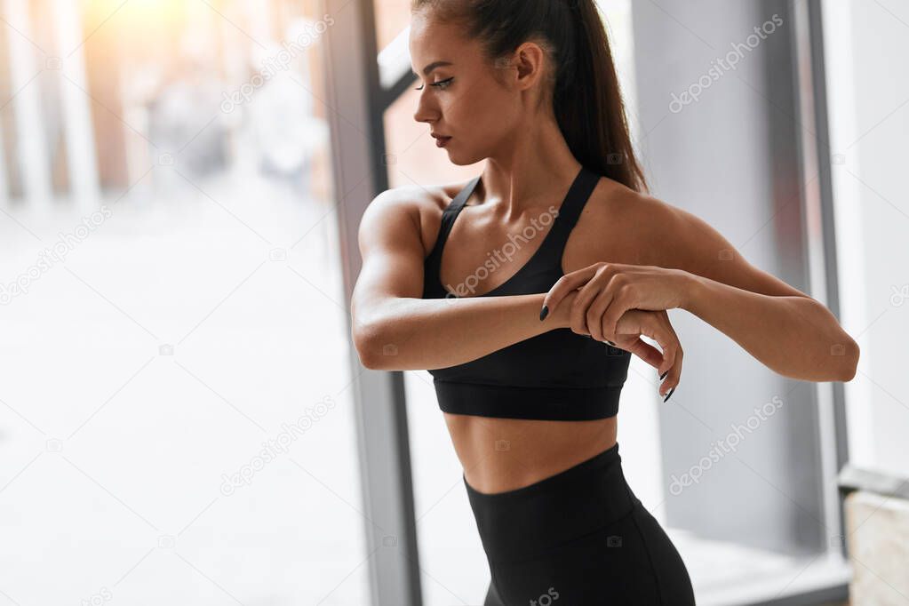 Beautiful caucasian girl stretching shoulder and arm muscles
