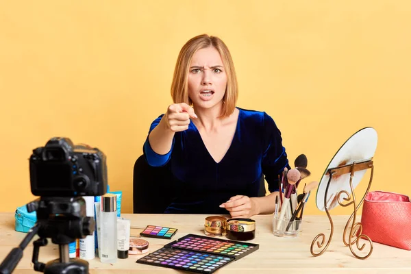 Irritated female vlogger points at camera with index finger, feels annoyed — Stock Photo, Image