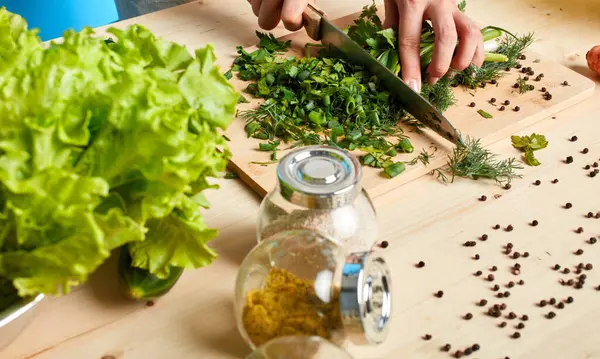 High angle view of hands chopping green lush vegetables, eco farm products — Stock Photo, Image