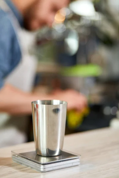 Metal coffee jug on scale — Stock Photo, Image