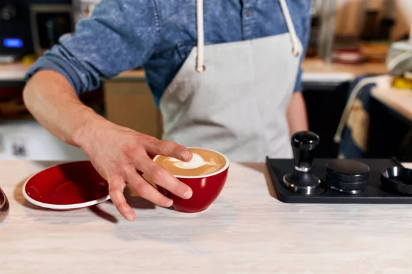 Handsome barista preparing cup of coffee for customer — Stock Photo, Image