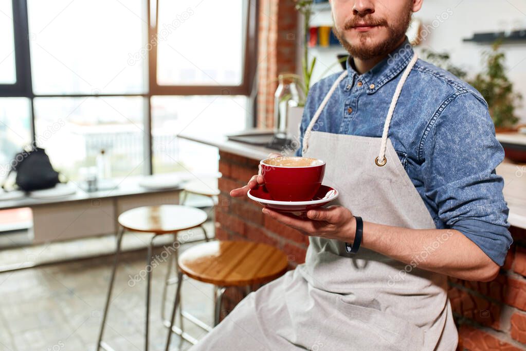 Hipster barista man with cup of coffee