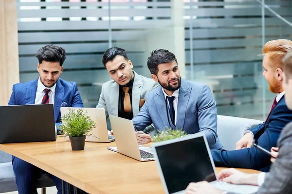 Reunião de parceiros de negócios multiculturais discutindo, usando laptop, tecnologias modernas — Fotografia de Stock