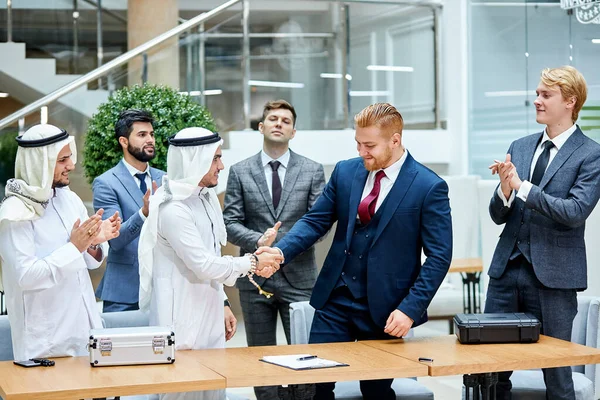 Sheikh make business deal with caucasian businessman. Business concept