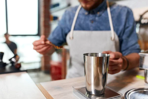 Knappe barman bereidt gemalen koffie voor klant — Stockfoto