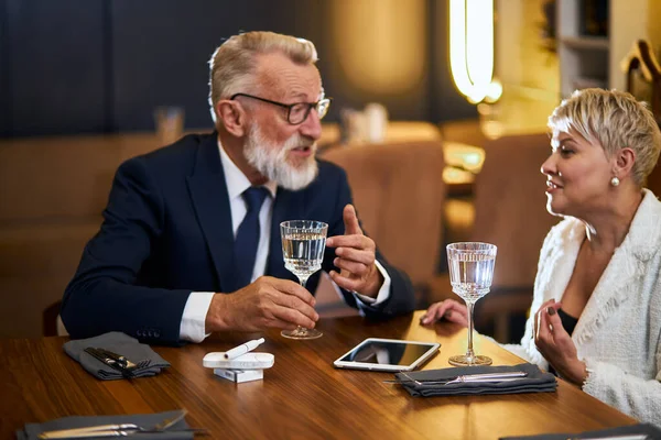 Äldre moderna vänner i restaurangen talar — Stockfoto