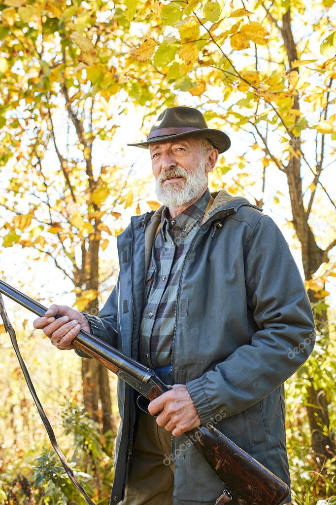 Senior hunter with gun ready to shoot his rifle