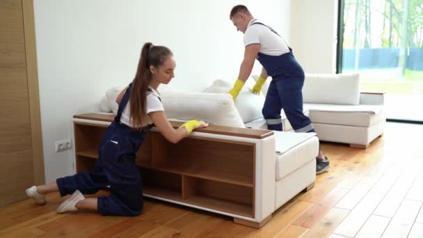 Two cleaners in uniform cleaning room — Stock Video