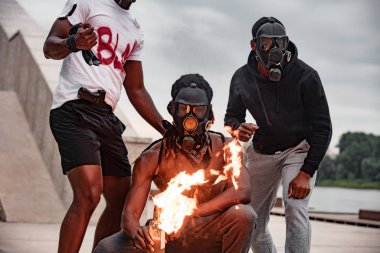 afroamerican men hold burning glass bottle in hands clipart