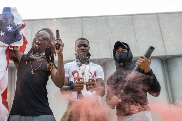 aggressive black people with guns in the streets