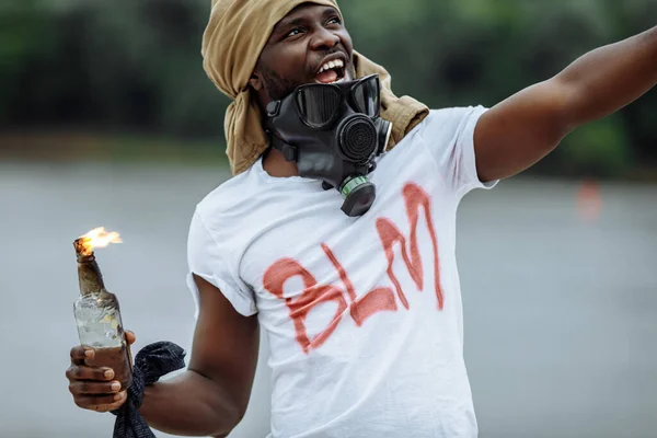 portrait of black man in gas mask