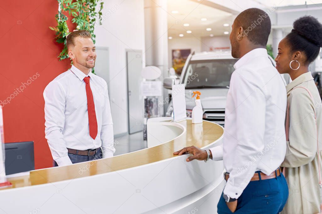 beautiful married couple entered modern dealership