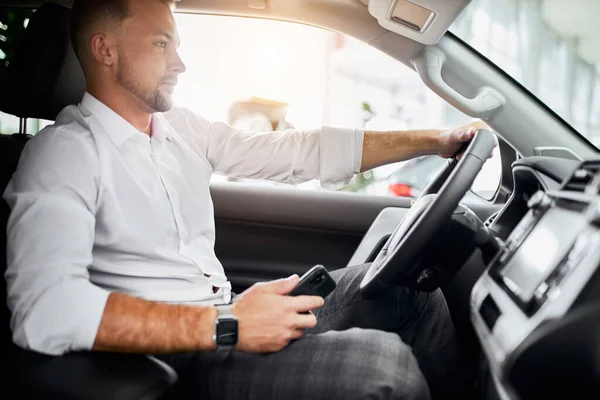 young caucasian business man test drive new car