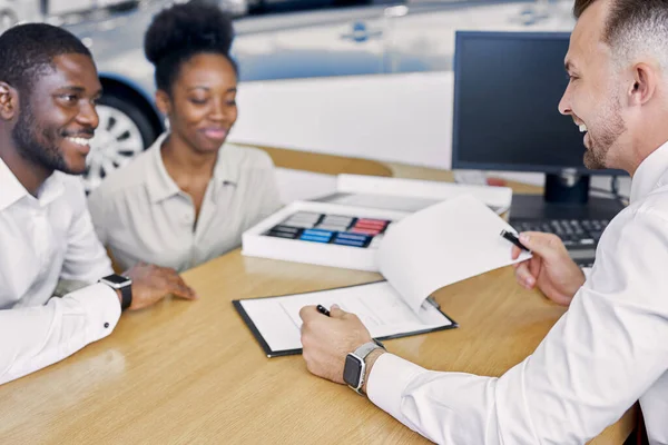 beautiful married couple get consultation in dealership