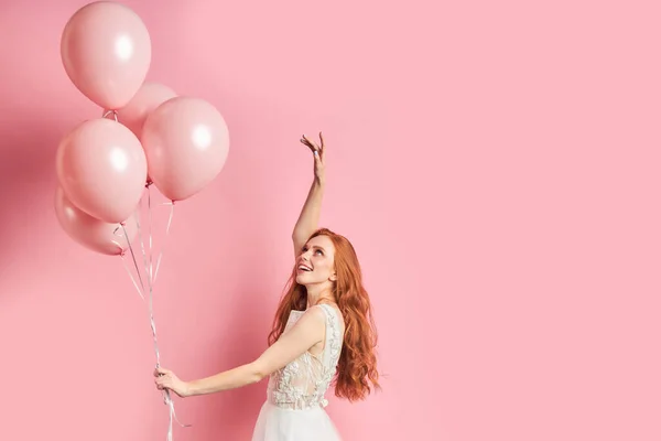 Joyful and attractive lady in white dress with air balloons — Stock Photo, Image