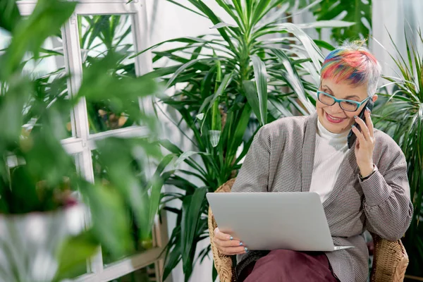 Empresária feliz sentado no centro de negócios com laptop e smartphone — Fotografia de Stock
