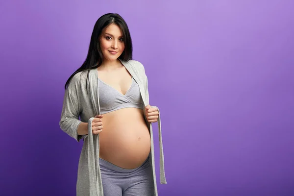 Mujer embarazada con 9 meses de expectativas emocionantes detrás, sostiene su barriga — Foto de Stock