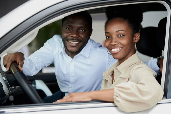 Família negra examinando carro de dentro — Fotografia de Stock