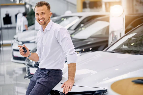 portrait of happy client man buying new car