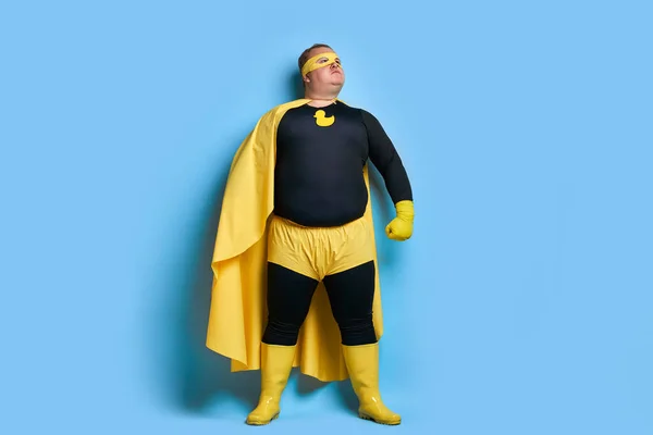 superhero fat male in mask and protective gloves
