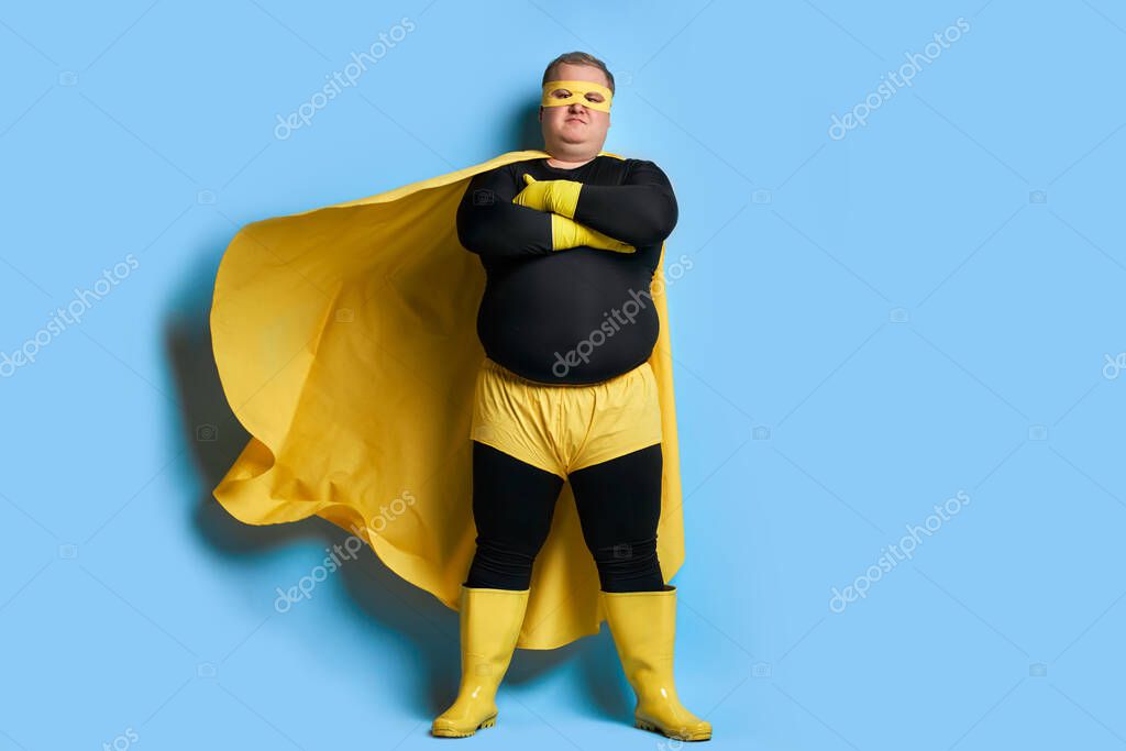 Serious overweight super hero man is defender of the universe, strong guy has a mad desire, a dream to shield the world from dirt and evil