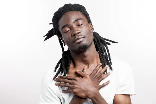 Thinking or dreaming african man with dreadlocks on white background — Stock Photo, Image