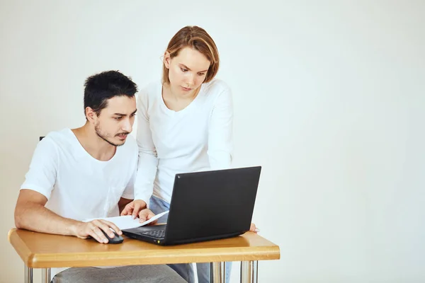 Pareja infeliz con facturas y laptop en casa, pagando impuestos — Foto de Stock