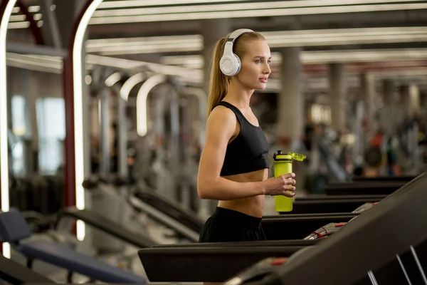 Sports blonde women on running track. female athlete on treadmill — Stock Photo, Image