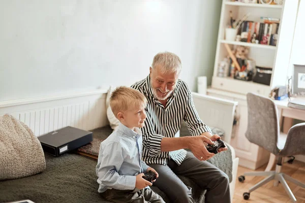 Abuelo y nieto jugando videojuegos en el ordenador con joystick — Foto de Stock