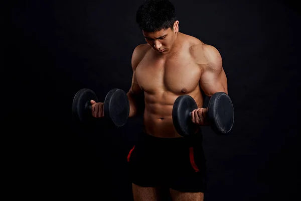 Serious man is concentrated on lifting weight — Stock Photo, Image