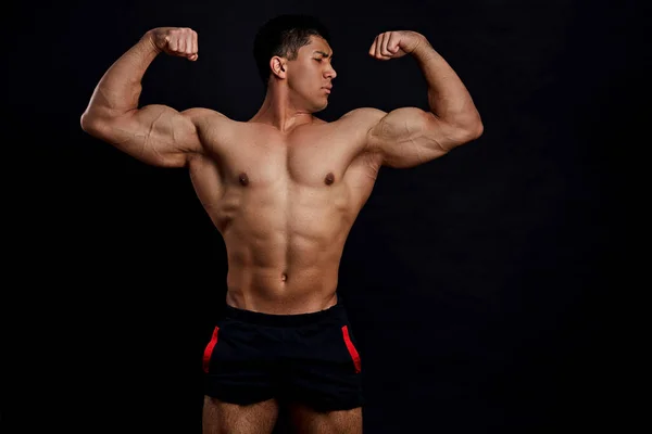 Sexy shirtless muscular athlete with raised hands — Stock Photo, Image