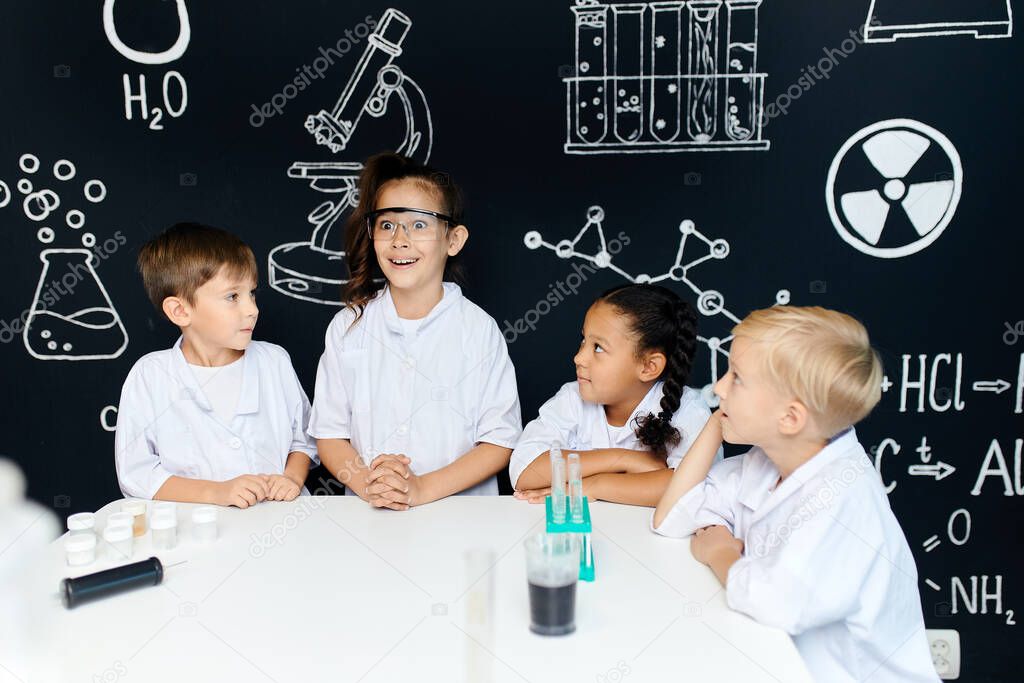 Small scientists kids with excited and happy faces having brilliant idea at lab